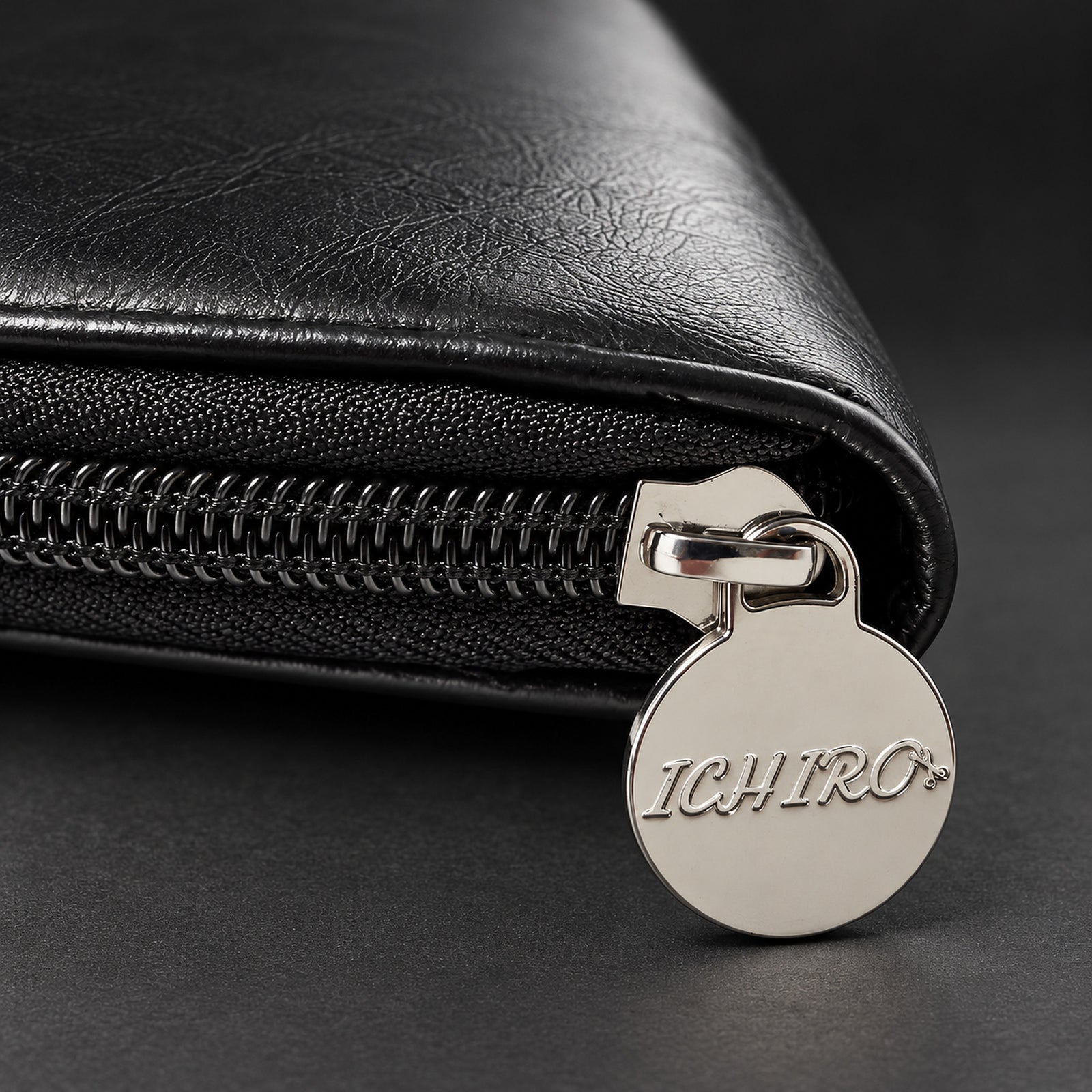 Detail of the engraved Ichiro zip puller on the hairdresser scissor case